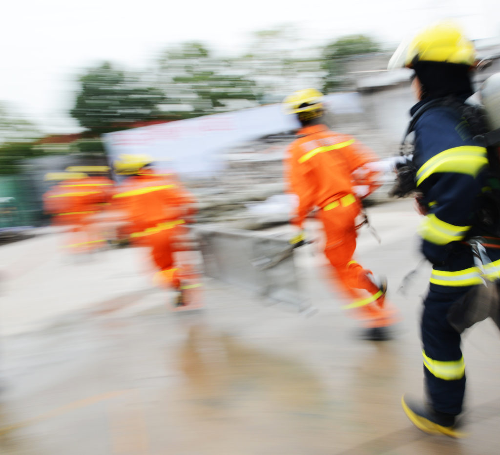 Search and rescue forces search through a destroyed building. blur motion