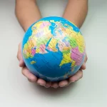 A globe being held in a pair of hands