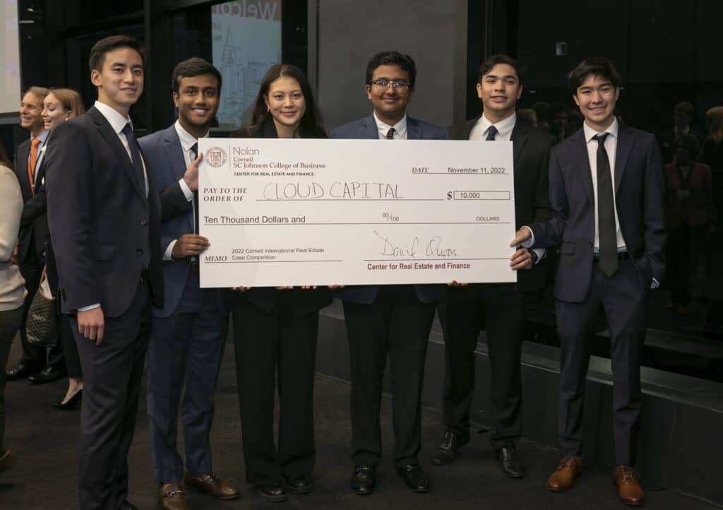 Winners of the JWP Case Competition hold the extra large check for 10,000.
