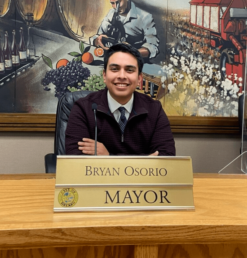 Mayor Bryan Osorio sitting behind desk with nameplate