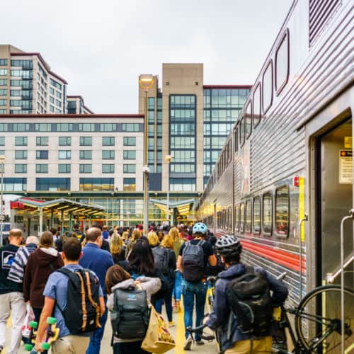 Crowds of people on a Caltrain platform after arriving in San Francisco