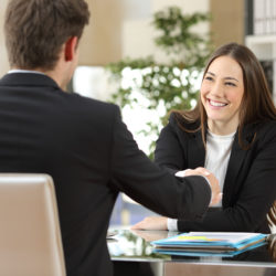 Businesspeople handshaking after negotiation or interview at office