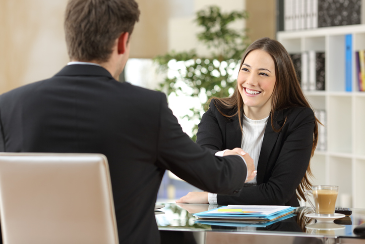 Businesspeople handshaking after negotiation or interview at office