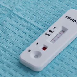 Covid 19 temperature reader on blue background