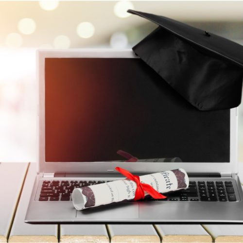 Laptop with graduation cap and diploma