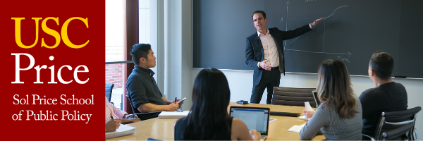 A professor teaching in front of the classroom.