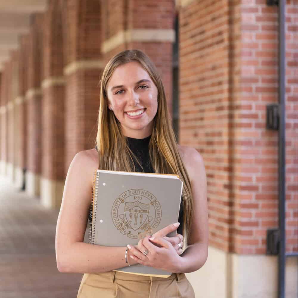 Female MPP student holding a USC folder