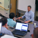 Professor Redfearn teaching in front of a classroom.