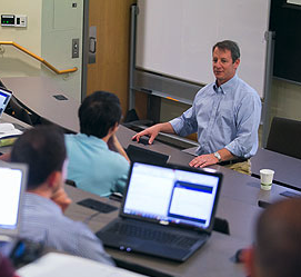 Professor Redfearn teaching in front of a classroom.