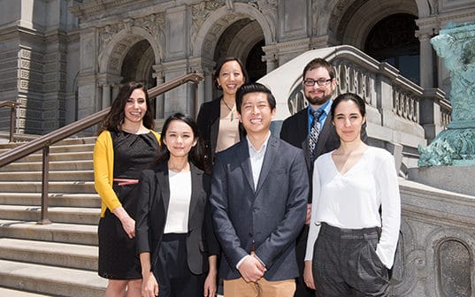 Master of Public Policy students standing in front of the stairs of a government building