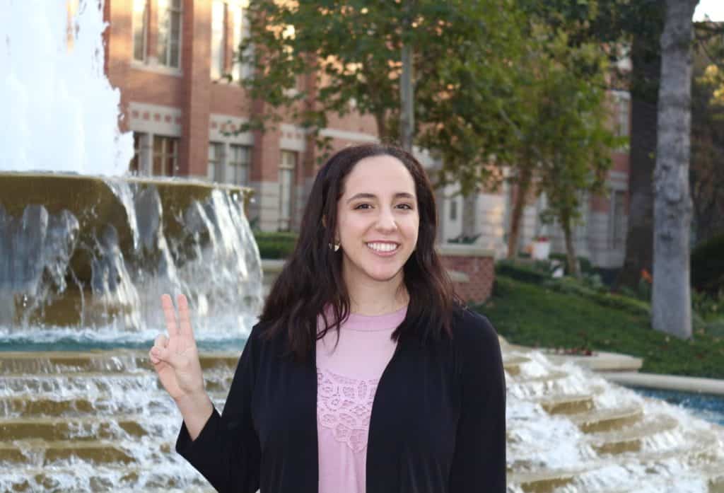 2021 Valedictorian Ariella Amit in front of fountain on USC campus