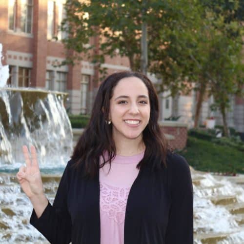 2021 Valedictorian Ariella Amit in front of fountain on USC campus