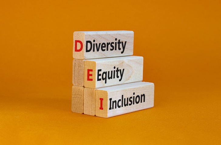 DEI, Diversity, equity, inclusion symbol. Wooden blocks with words DEI, diversity, equity, inclusion on beautiful orange background. Business, DEI, diversity, equity, inclusion concept.