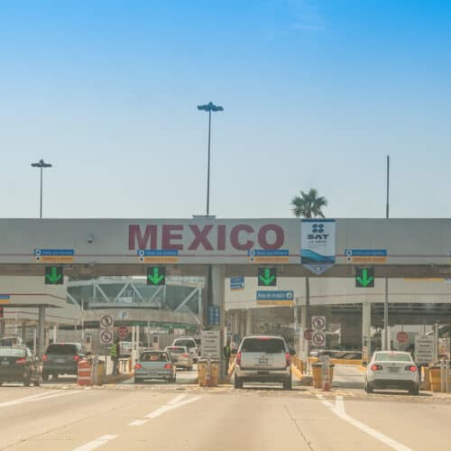 stock image of cars waiting to pass through US-Mexico border control