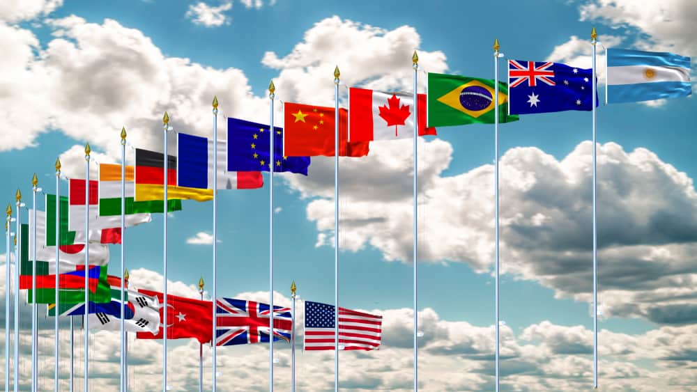 photograph of flags from around the world blowing in the wind on a sunny day