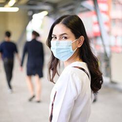 A young woman is wearing face mask in the Street city, Coronavirus protection, lifestyle under pandemic, Health care concept.