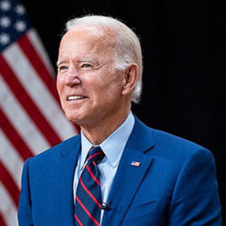 headshot of President Joe Biden with US flag behind him