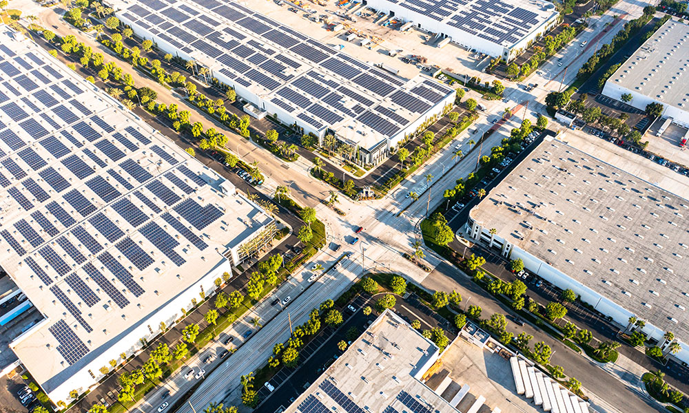 Drone view of warehouse roofs covered with solar panels