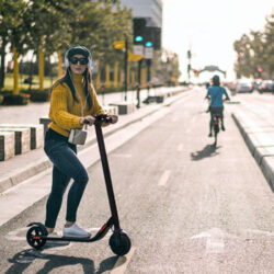 A woman rides an electric scooter in Los Angeles.