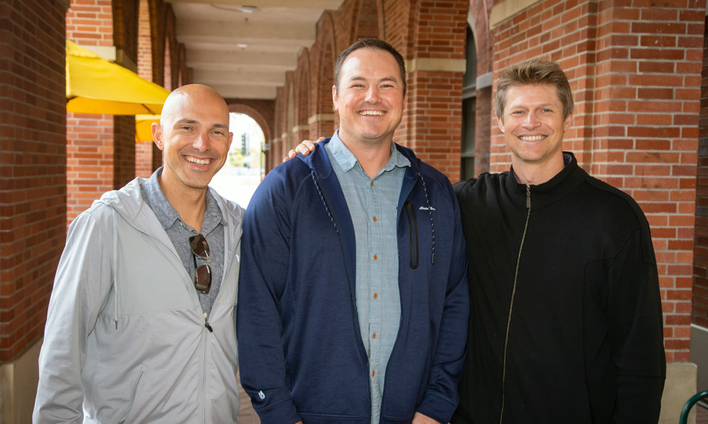 Adam Weiss, Andrew Padilla and Ryan Tyler pose for a picture outside a USC campus building