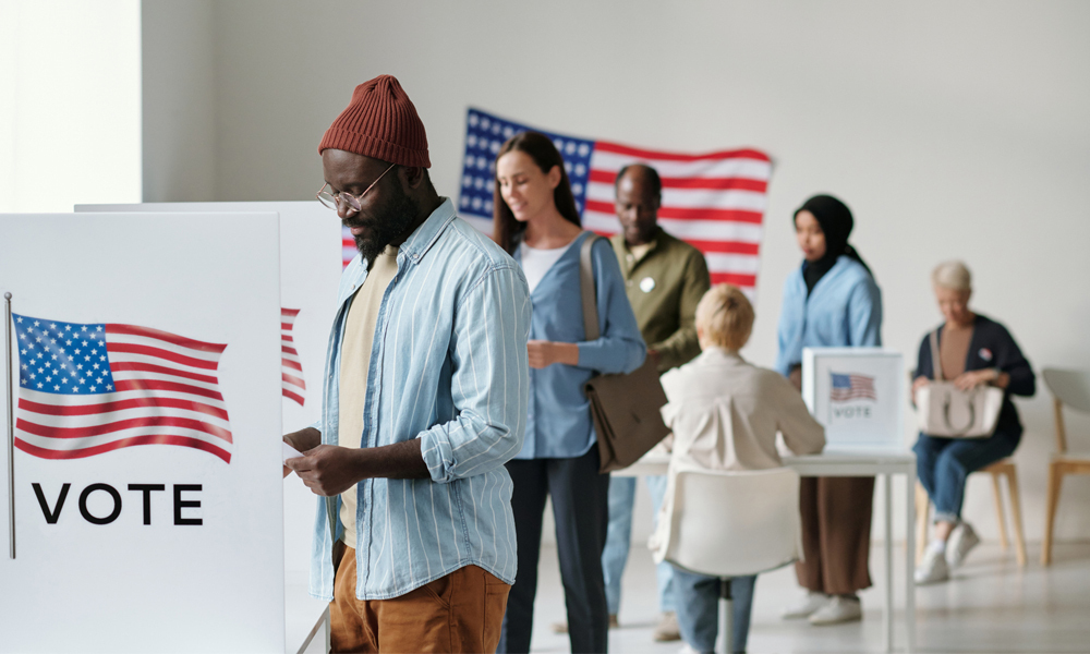 Voters wait in line to cast ballots