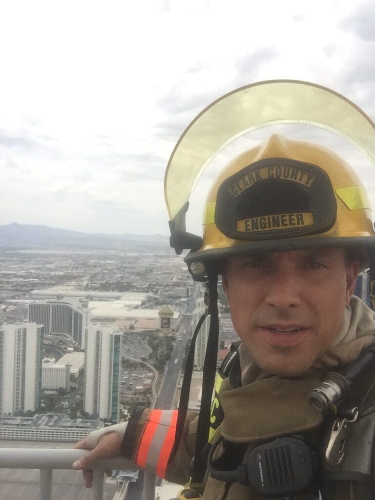 Andrew Padilla poses for a picture with the Vegas skyline behind him. 