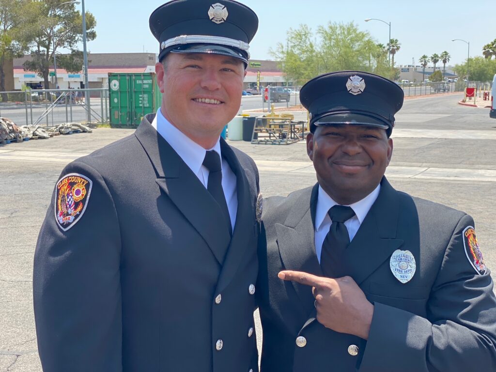 Ryan Tyler and a colleague pose for a picture in their uniforms. 