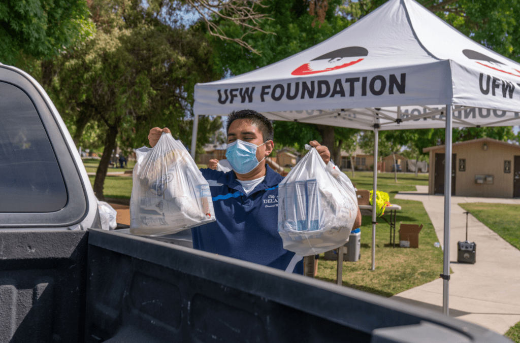 Bryan Osorio volunteering, putting groceries into pick-up truck