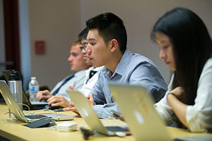 Students working on laptops in the classroom.