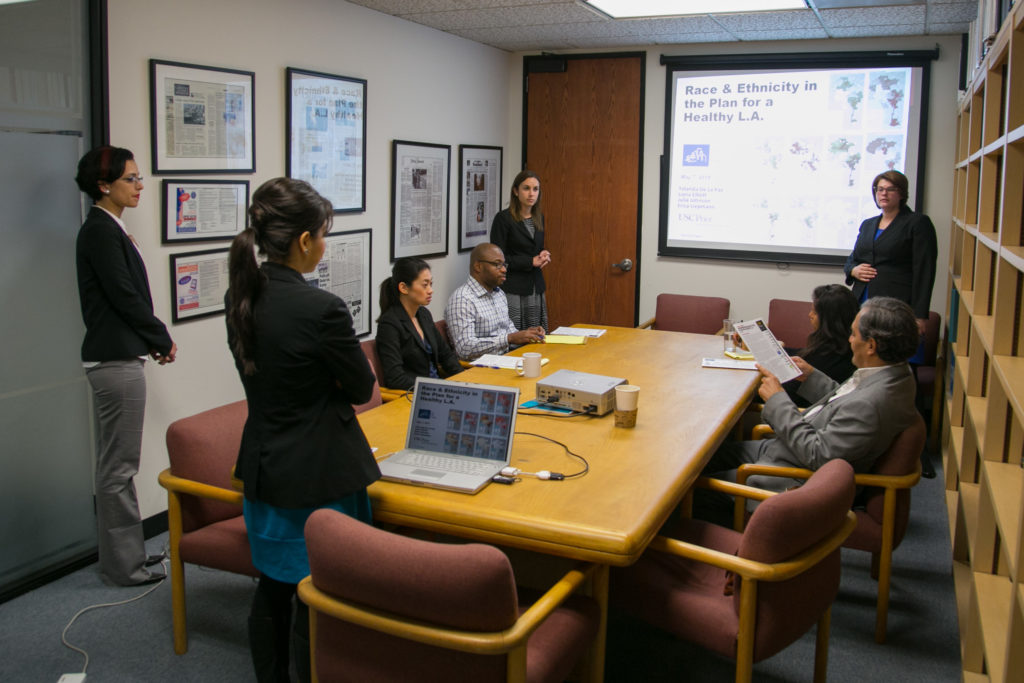 Students presenting in a conference room.