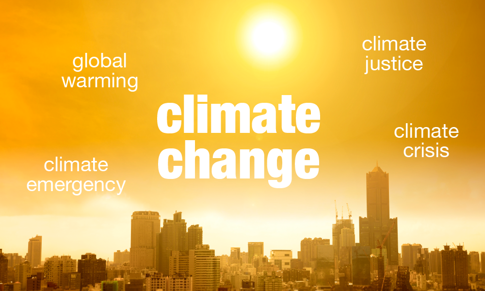 A composite showing a city skyline under a hit sun and words in the sky that say "climate change," "global warming," "climate justice," climate emergency" and "climate crisis."