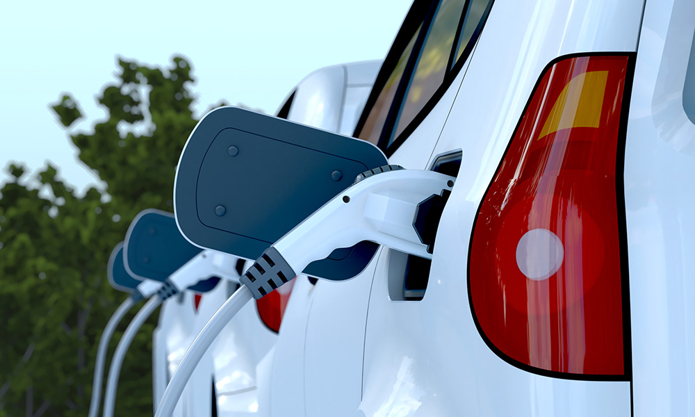 a row of electric cars charging