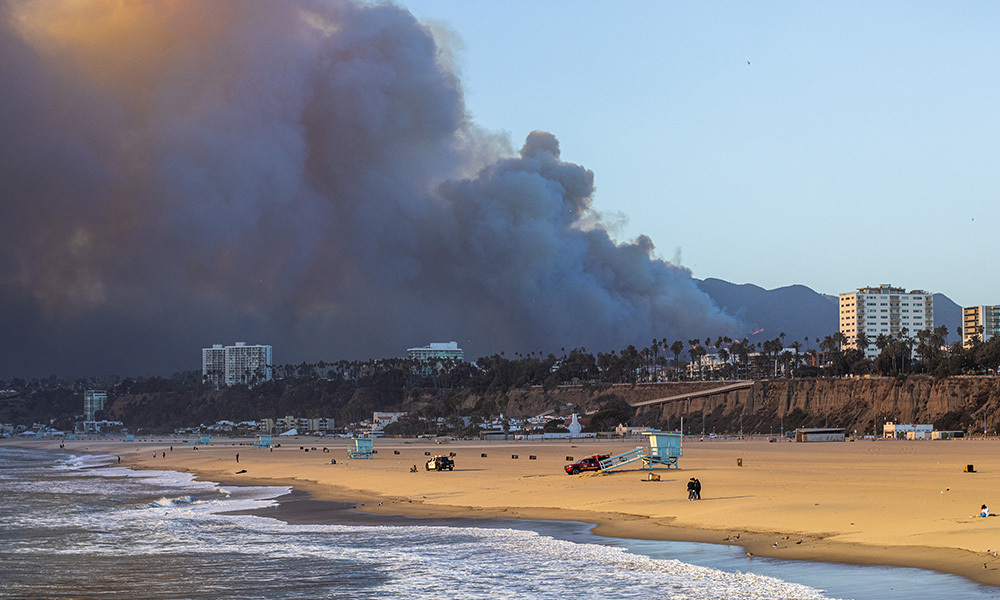 The Pacific Palisades fire burns near Los Angeles, California, with huge plumes of smoke seen from Santa Monica Beach.