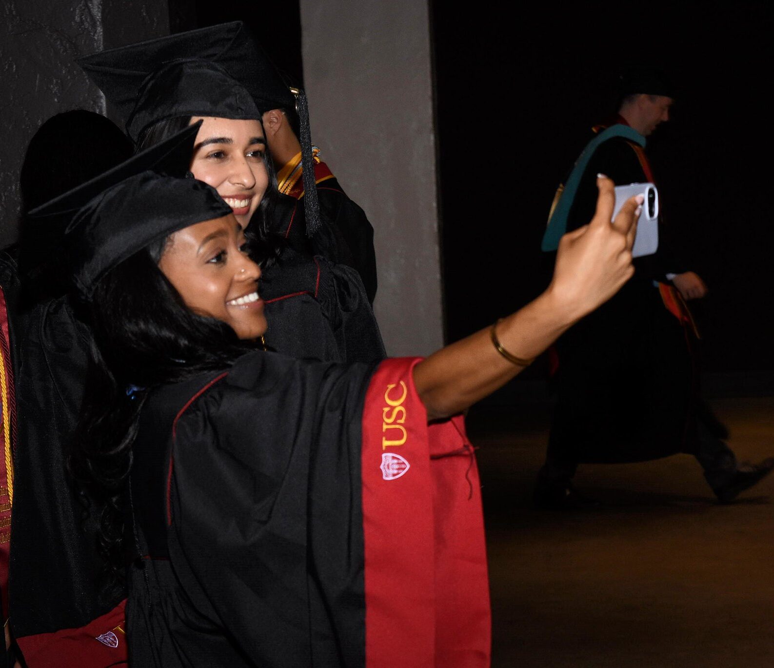 USC Price students taking a selfie with friends at Commencement