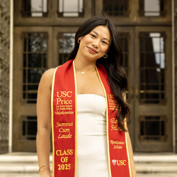 Sydnee Yu poses for a picture in front of an academic building on USC campus.