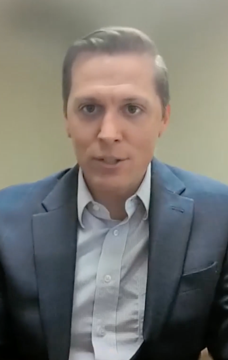 Man wearing a navy suit.